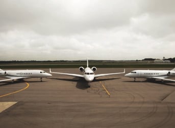 Three Stryker Aircraft on Runway with Sky in Background