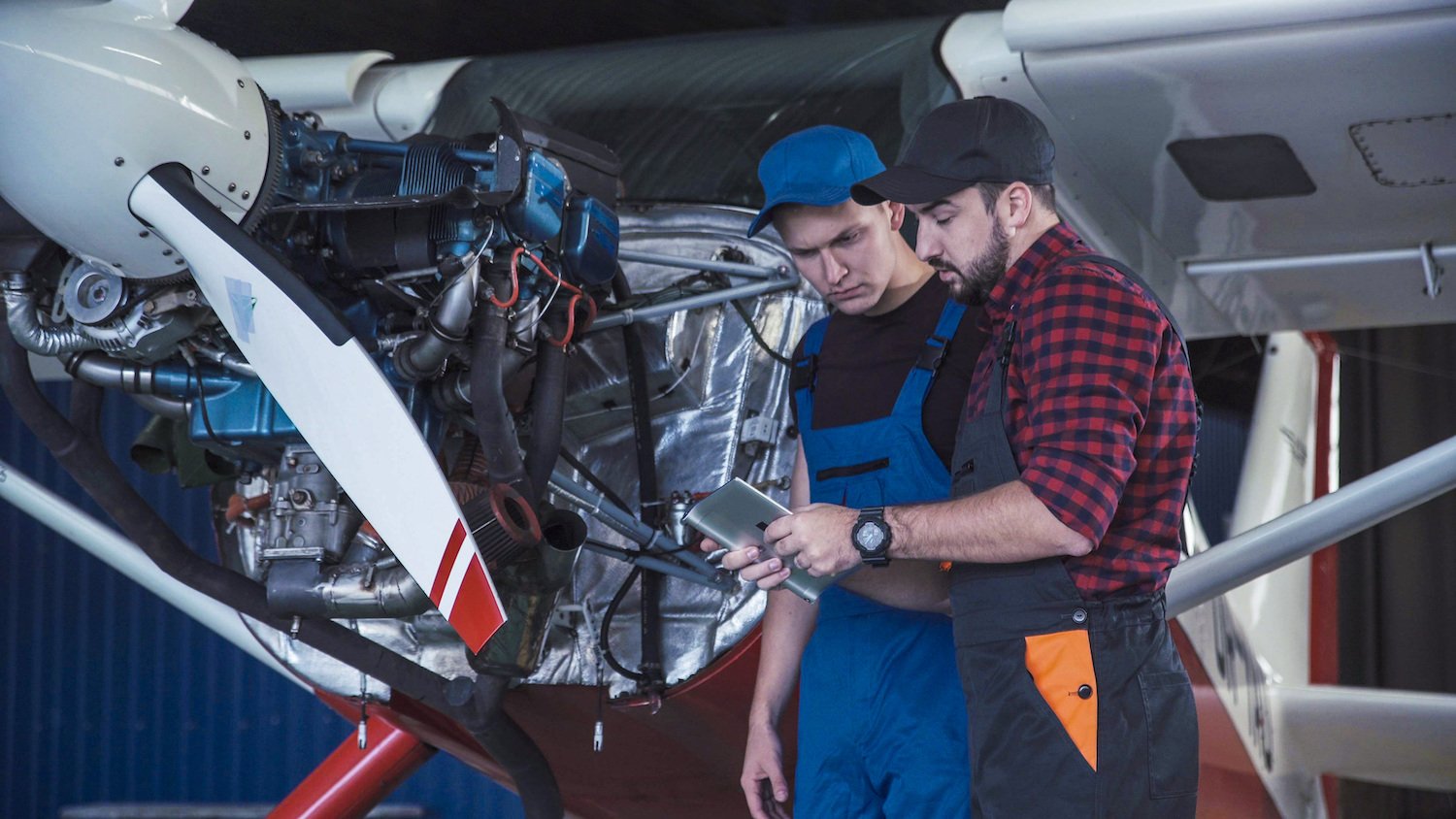 technician talking to another technician about plane troubleshooting